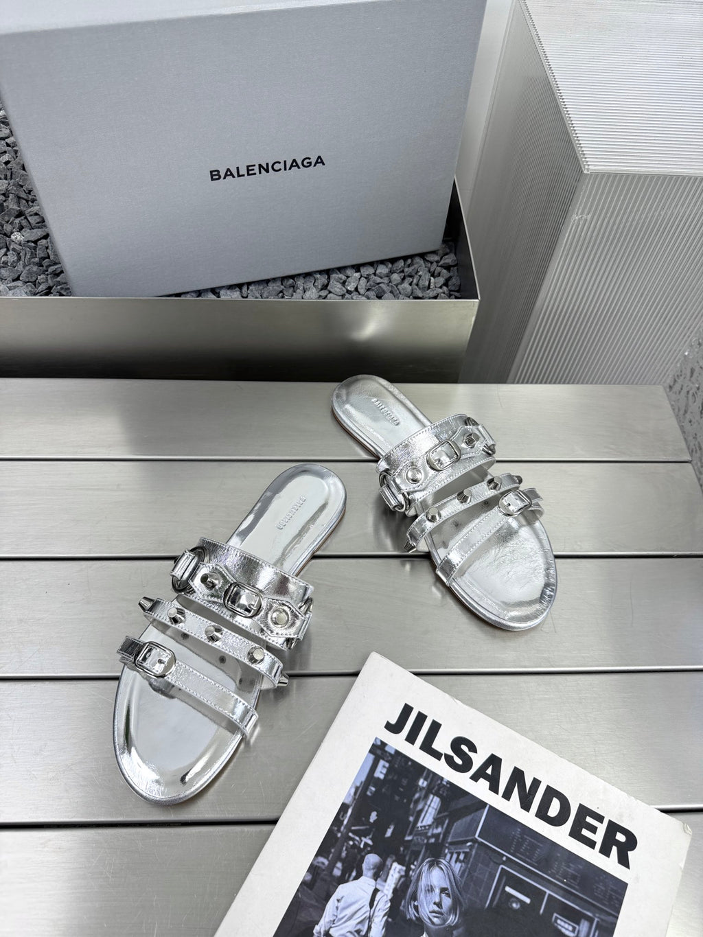 Silver metallic sandals with adjustable buckles and glossy studded strap details