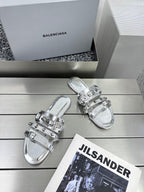 Silver metallic sandals with adjustable buckles and glossy studded strap details