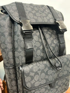 Charcoal monogram backpack close-up with front strap buckles and cord