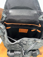 Charcoal monogram backpack interior pocket with orange trim and logo patch