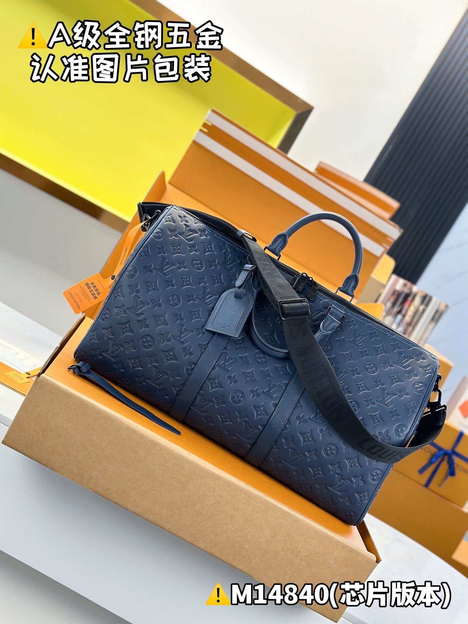 Dark blue embossed monogram duffel bag with top handle loop and wide strap