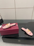 Light pink Gucci slide sandals with gold H-bit hardware, one placed beside the box