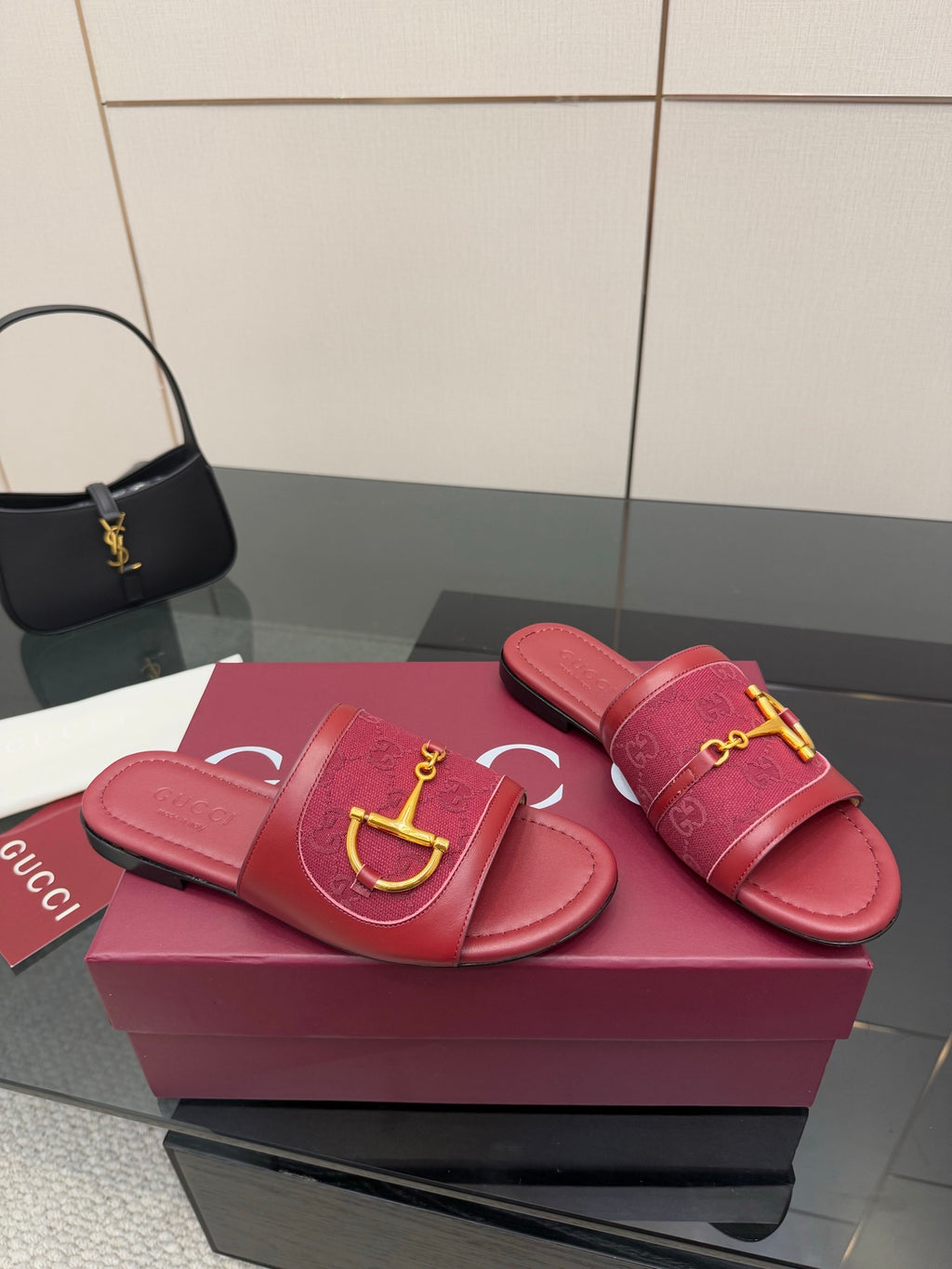 Women’s Gucci slide sandals, dark red leather with gold horsebit detail, side view