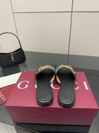 Gucci ladies slide sandals showing front openings, gray GG strap with yellow hardware