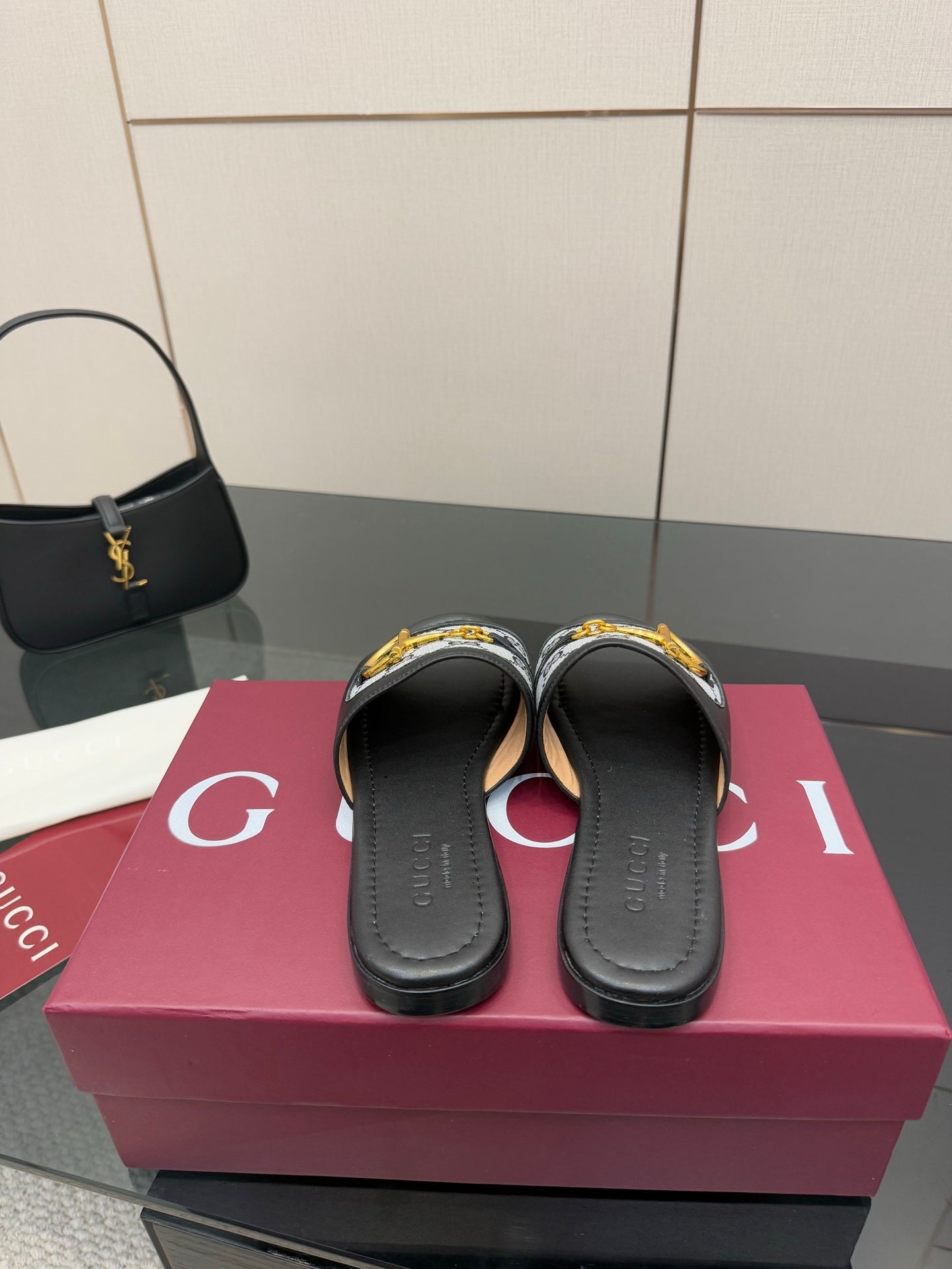 Gucci ladies slide sandals showing front openings, gray GG strap with yellow hardware