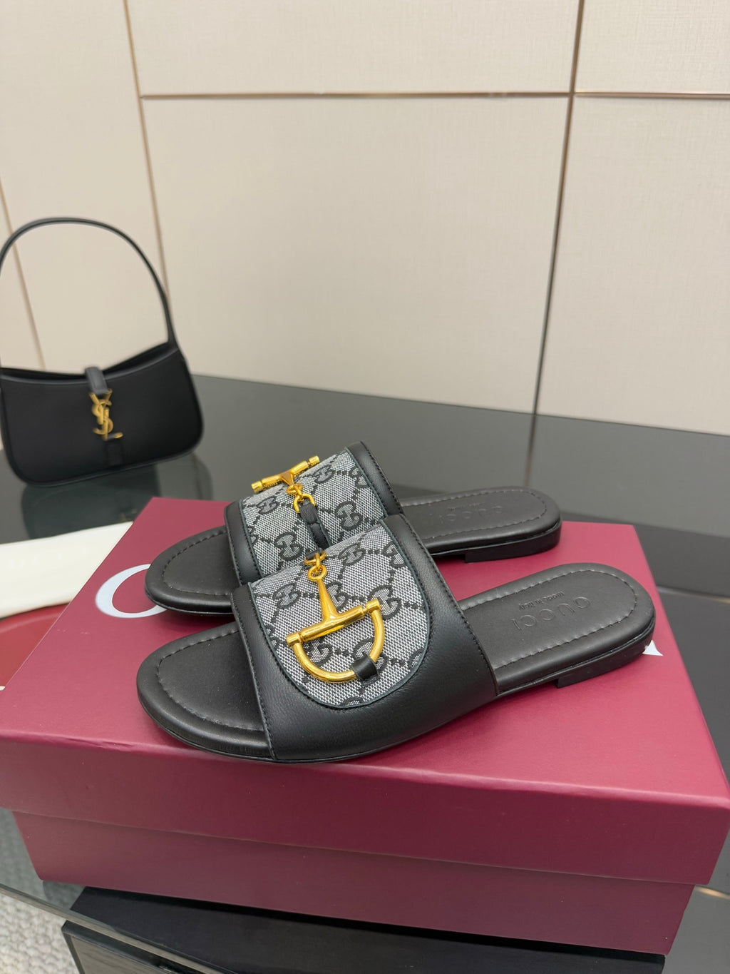 Gucci ladies slide sandals with black leather straps and gray GG canvas with yellow bit detail