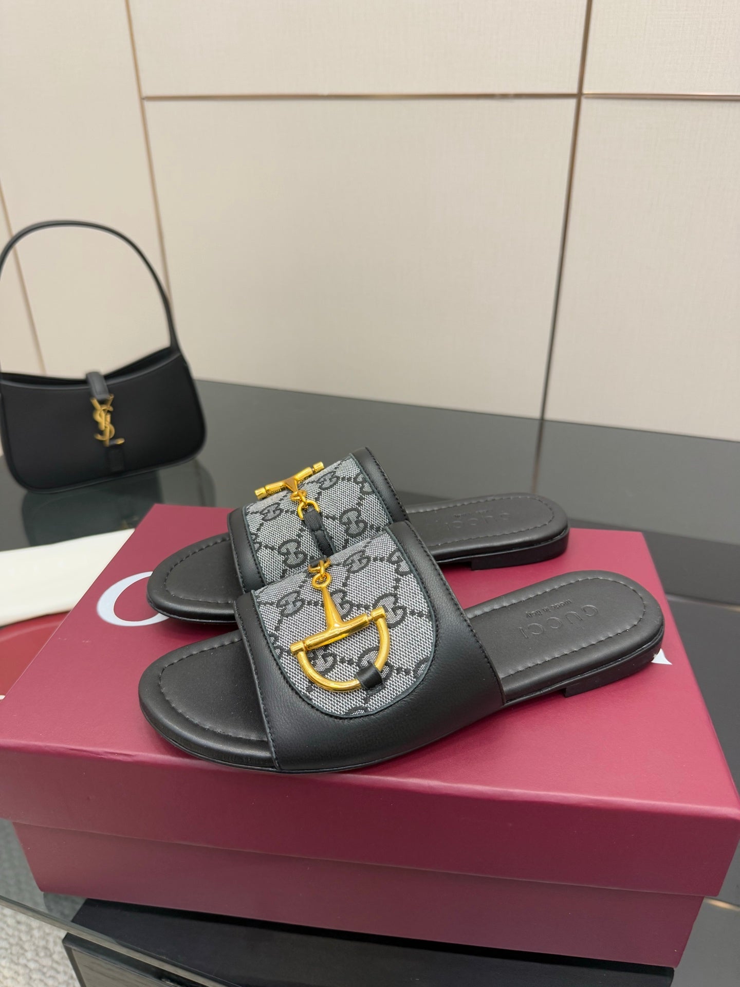 Gucci ladies slide sandals with black leather straps and gray GG canvas with yellow bit detail
