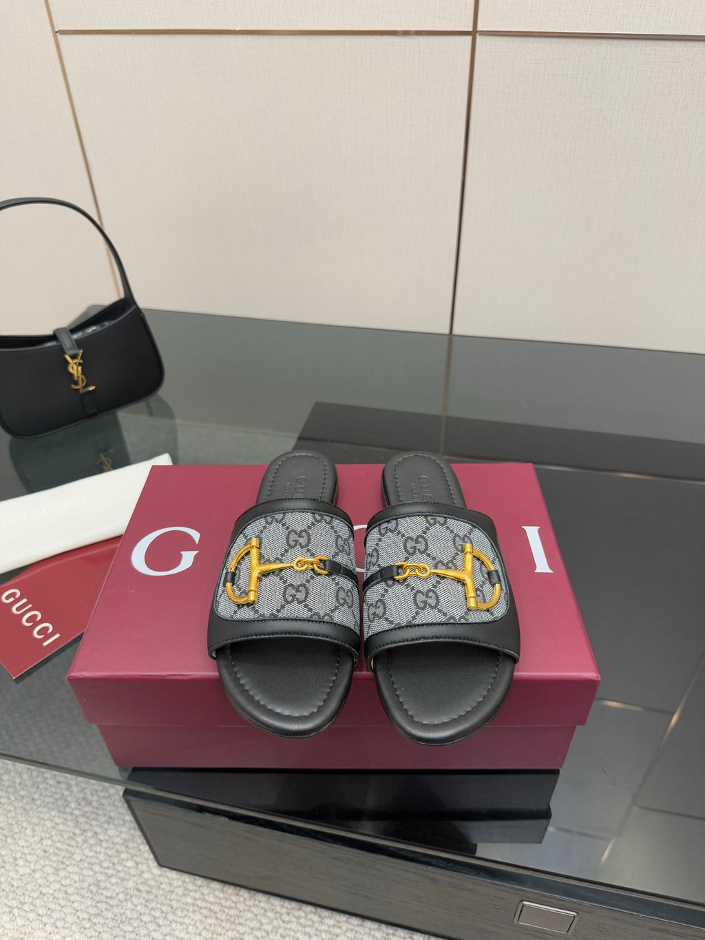 Gucci ladies slide sandals with gray GG canvas straps, black leather, yellow hardware
