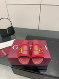 Women's Gucci red slide sandals with gold-toned horsebit strap across