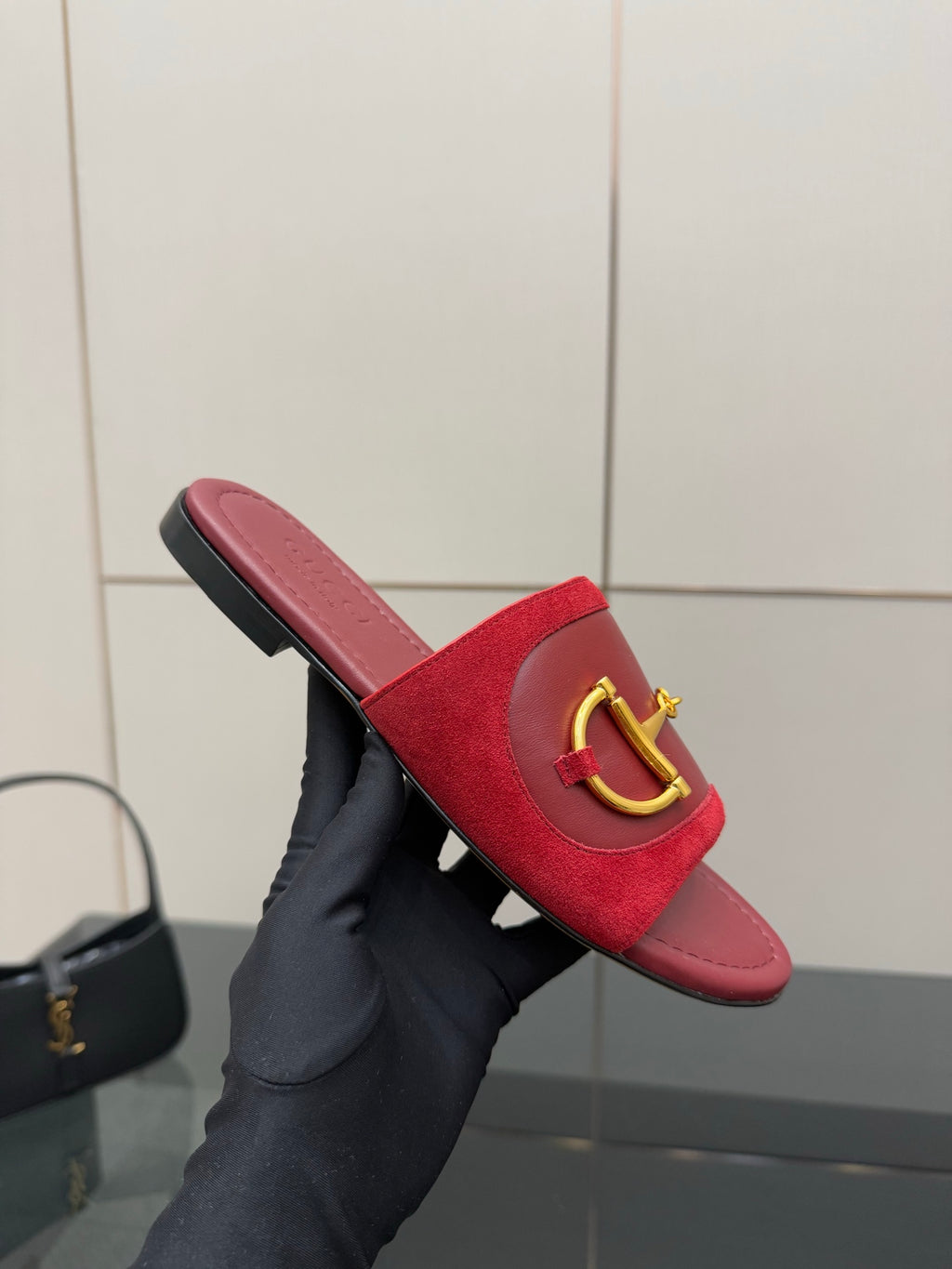 Women's Gucci red mule slides with gold-toned horsebit strap and black-trim sole