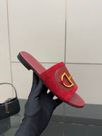 Women's Gucci red mule slides with gold-toned horsebit strap and black-trim sole