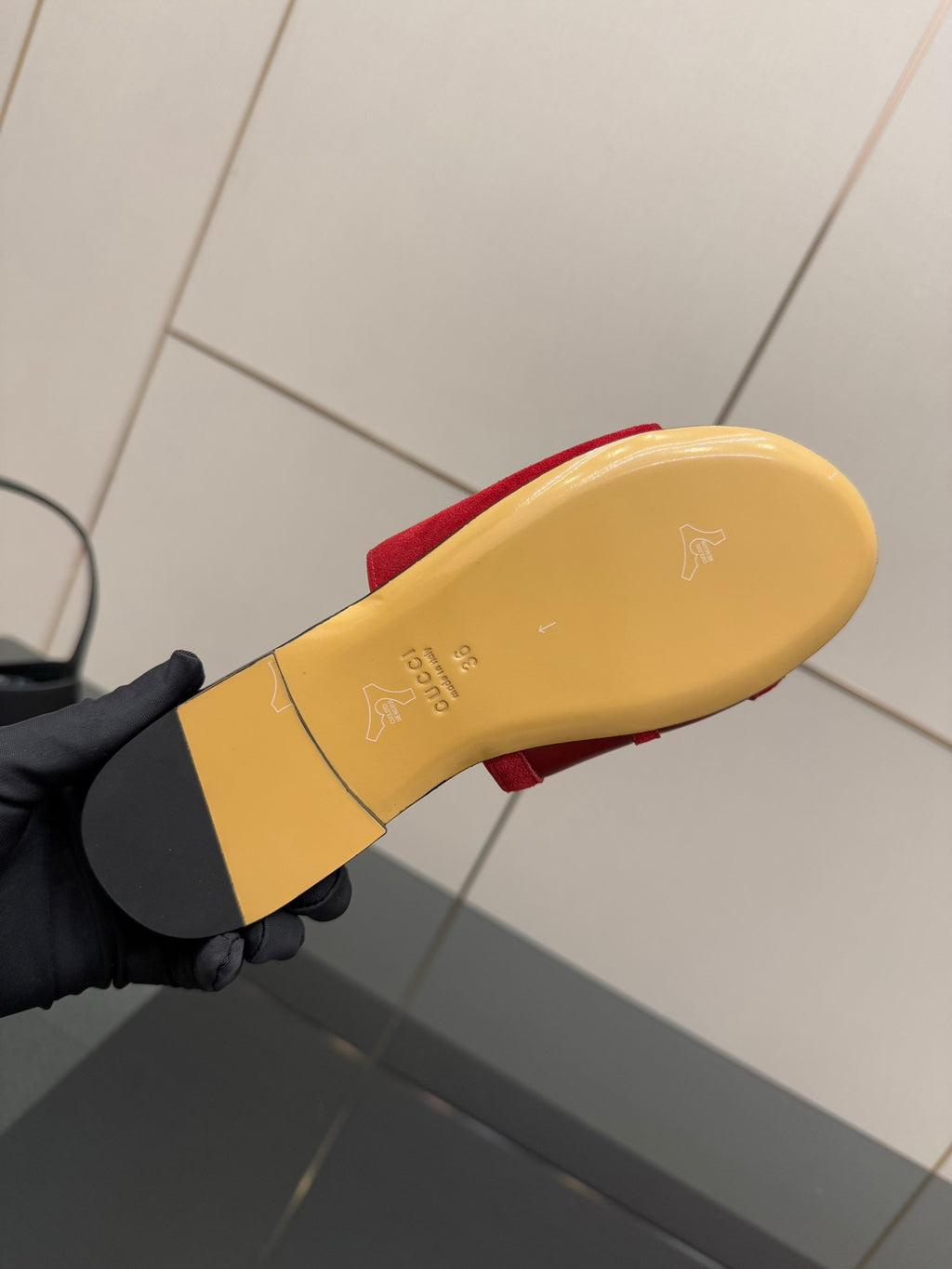Women's Gucci red slide sandal outsole, yellow underside with small logo mark