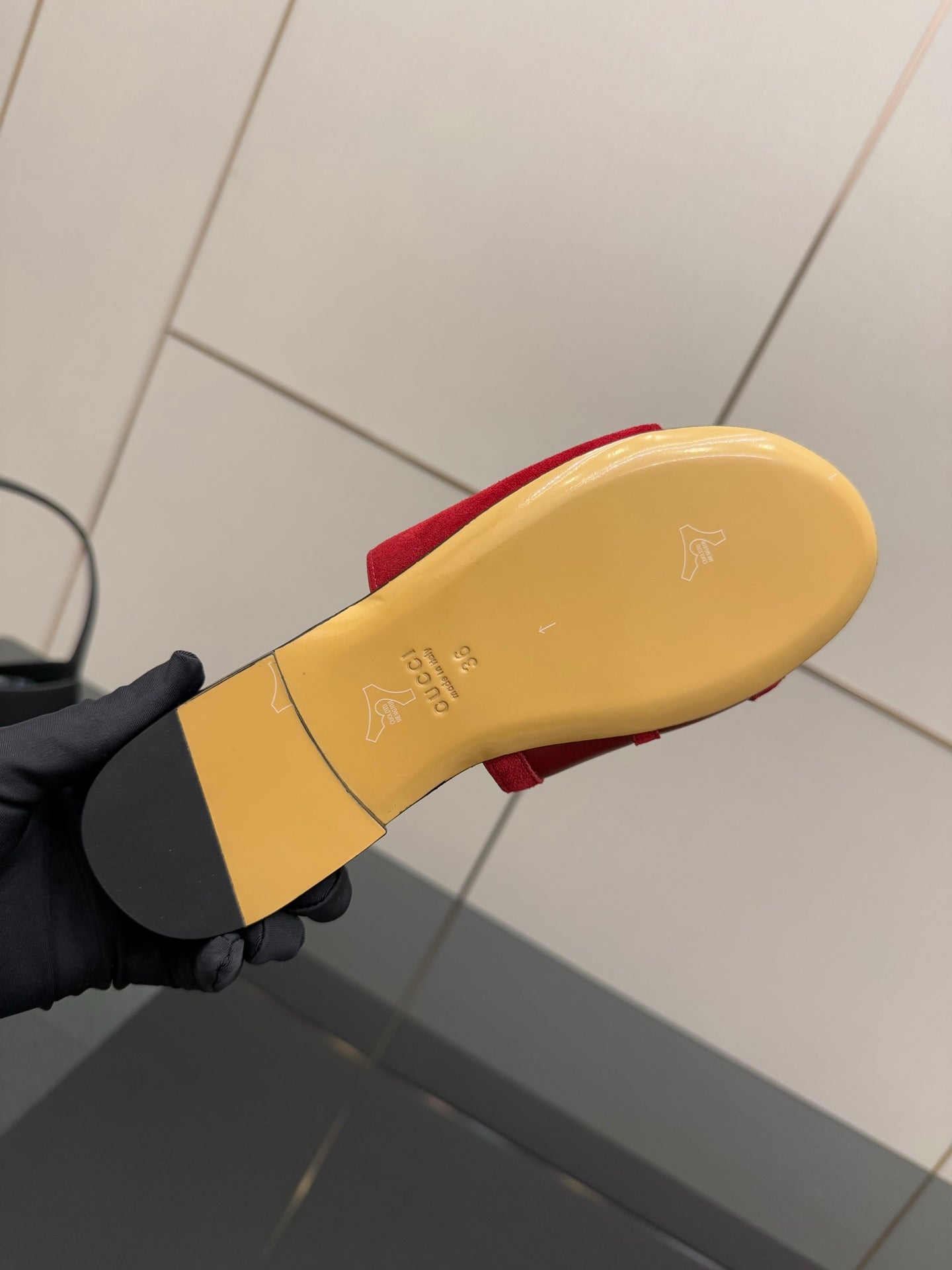 Women's Gucci red slide sandal outsole, yellow underside with small logo mark