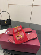 Women's Gucci red mule slides with gold-toned horsebit ornament and footbed