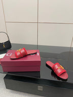 Women's Gucci red slide sandals with gold-toned horsebit strap, side view