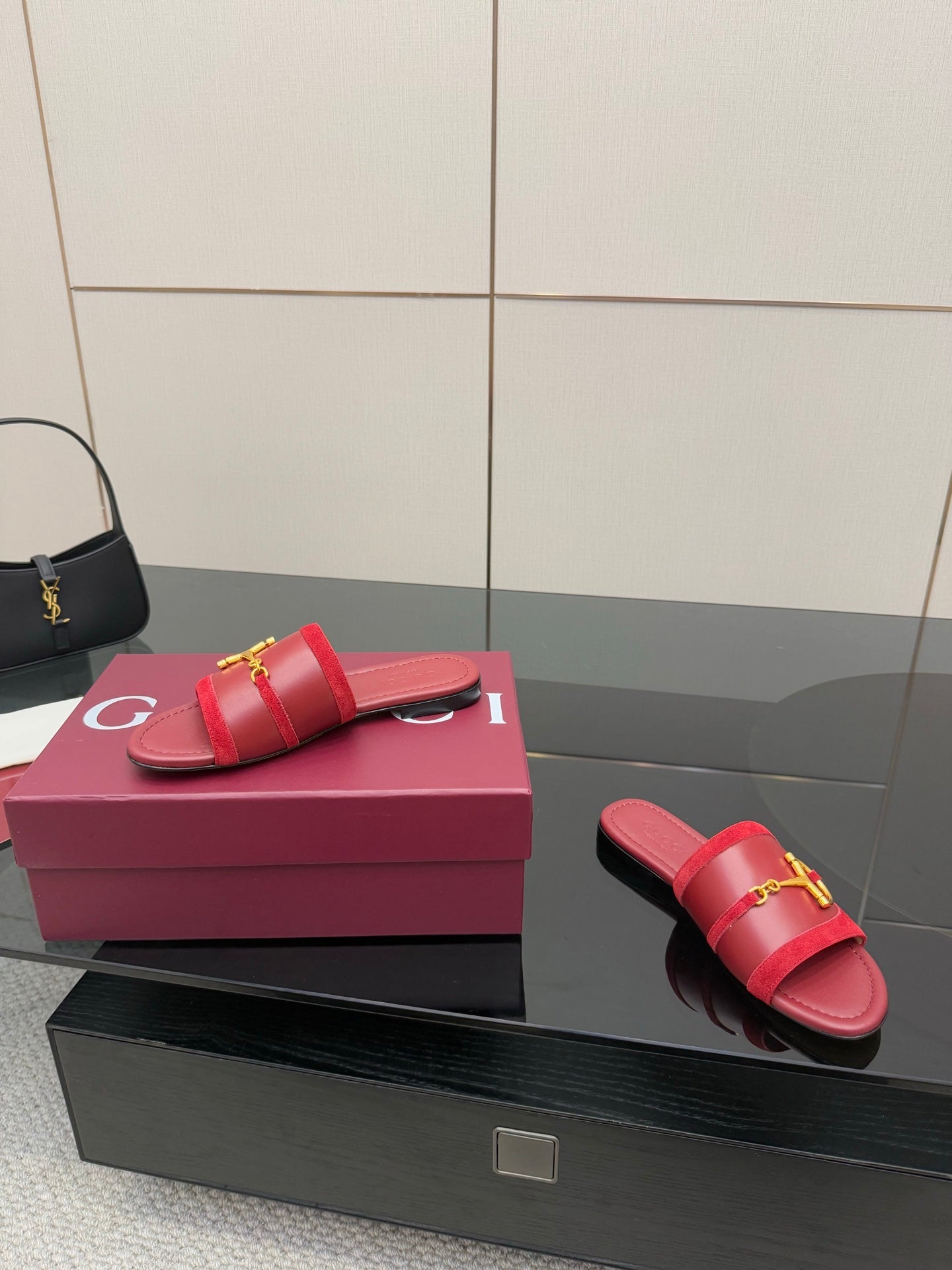 Women's Gucci red slide sandals with gold-toned horsebit strap, side view