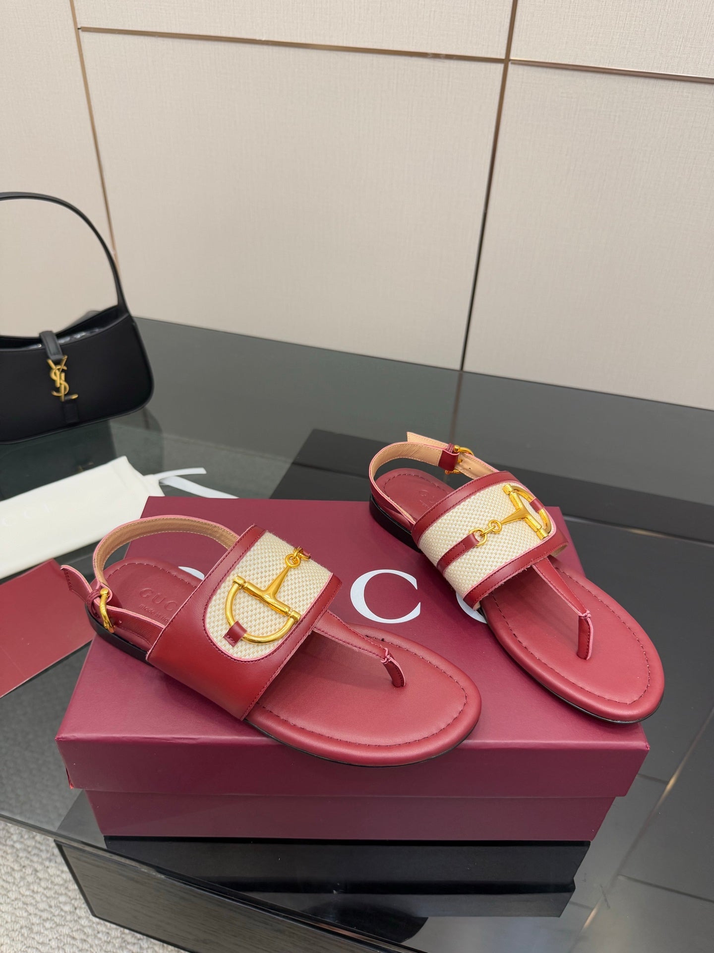 Red slide sandals with gold buckle ornament and thong toe strap