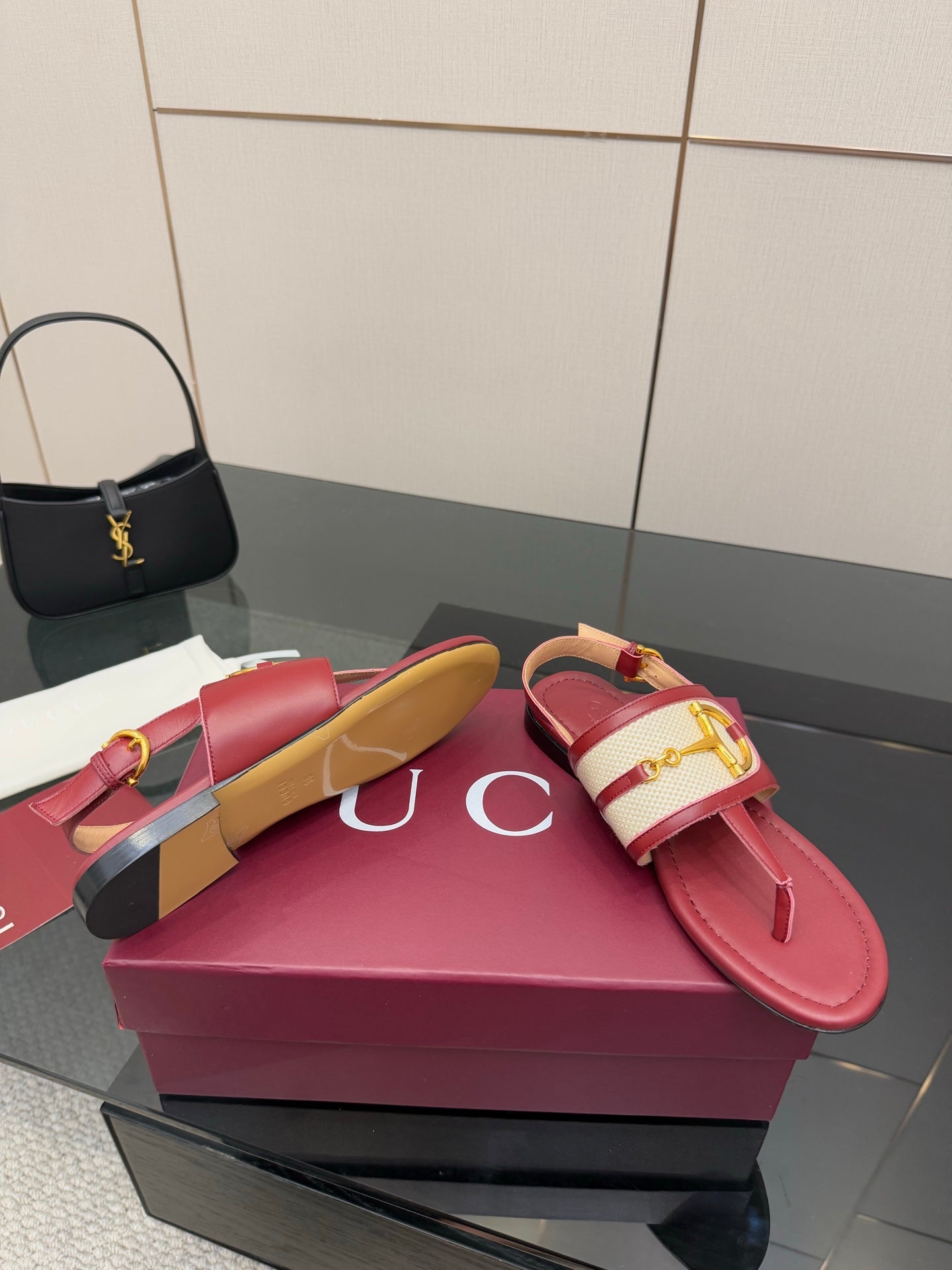 Red leather slide sandals with gold logo buckle and slingback strap