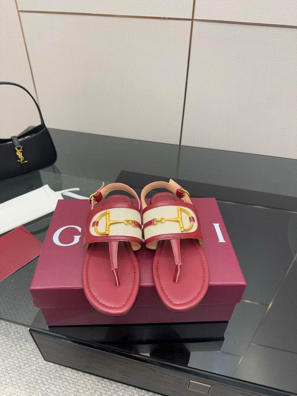 Red leather slide sandals with Y-style gold buckle detail and textured strap