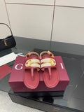 Red leather slide sandals with Y-style gold buckle detail and textured strap