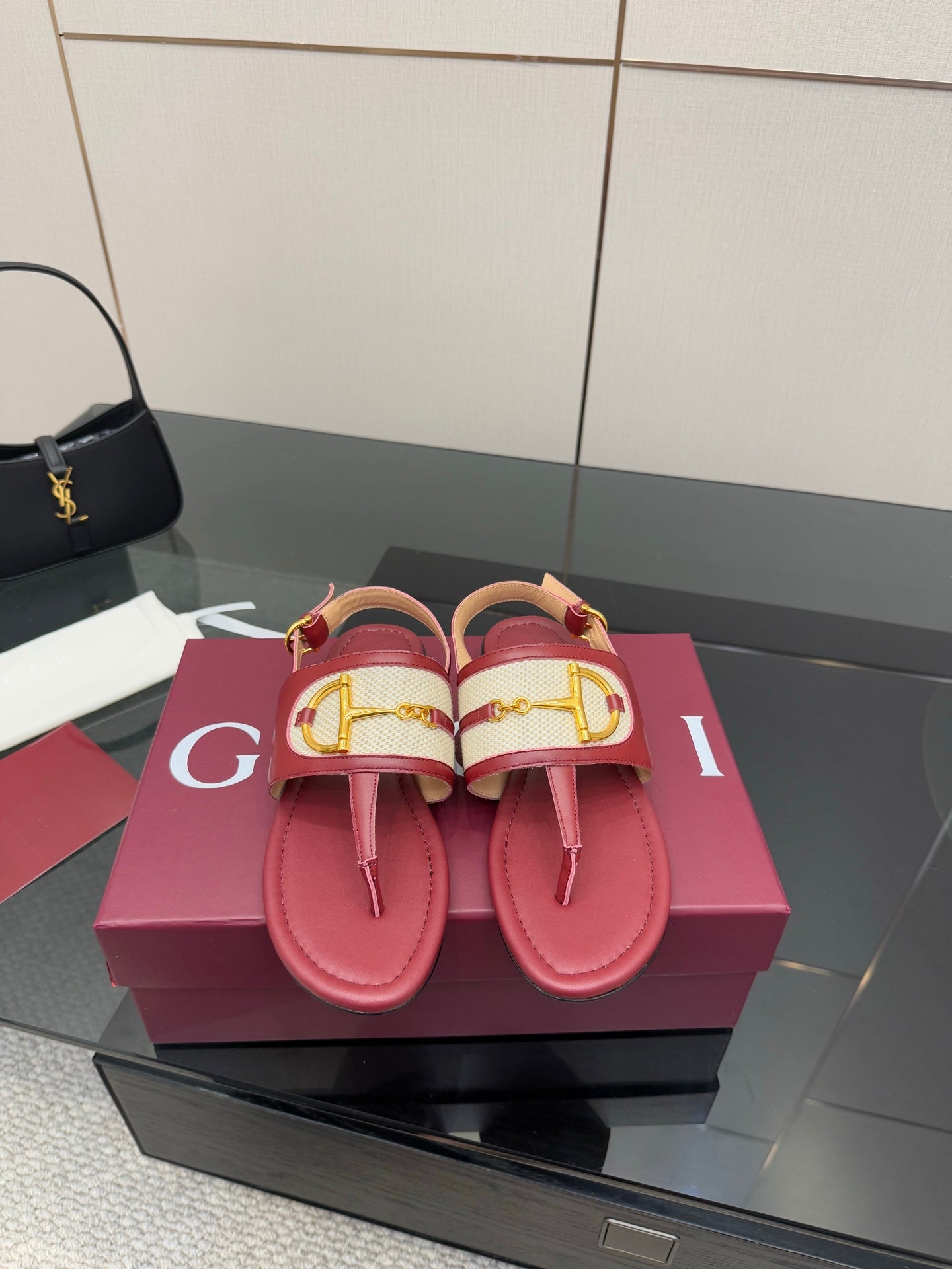 Red leather slide sandals with Y-style gold buckle detail and textured strap