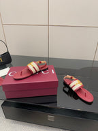 Red thong sandals with gold buckle on patterned strap and open toe