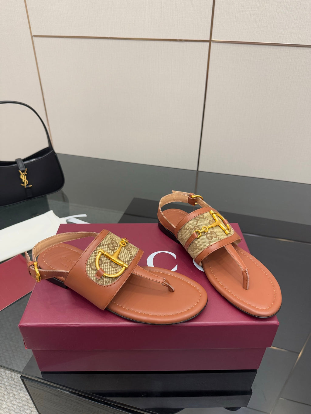 Gucci ladies thong sandals with tan footbed and patterned strap, gold buckle detail