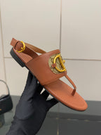 Gucci ladies thong sandals with tan strap and gold logo hardware, flat sole
