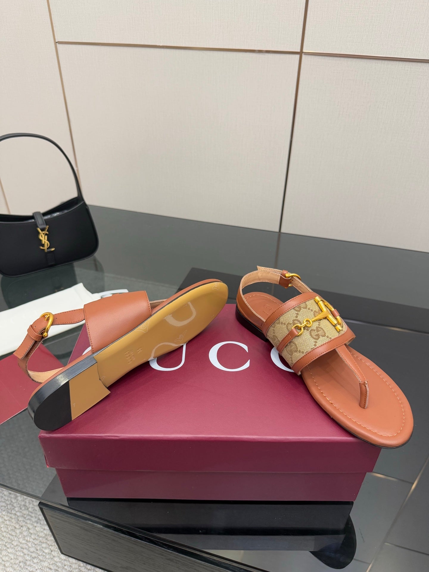 Gucci ladies thong sandals, tan footbed and logo patterned strap with gold buckle