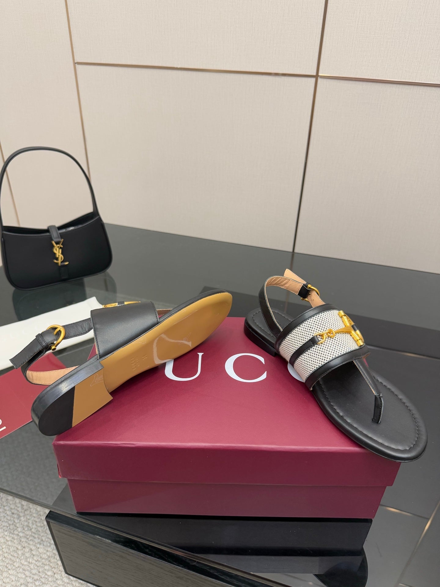 Ladies slide sandals on box: black leather strap with white check panel and gold buckle