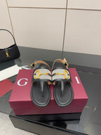 Ladies slide sandals with black leather straps and gold G buckle detail