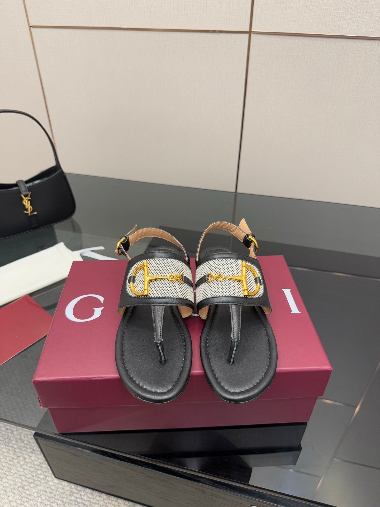 Ladies slide sandals with black leather straps and gold G buckle detail