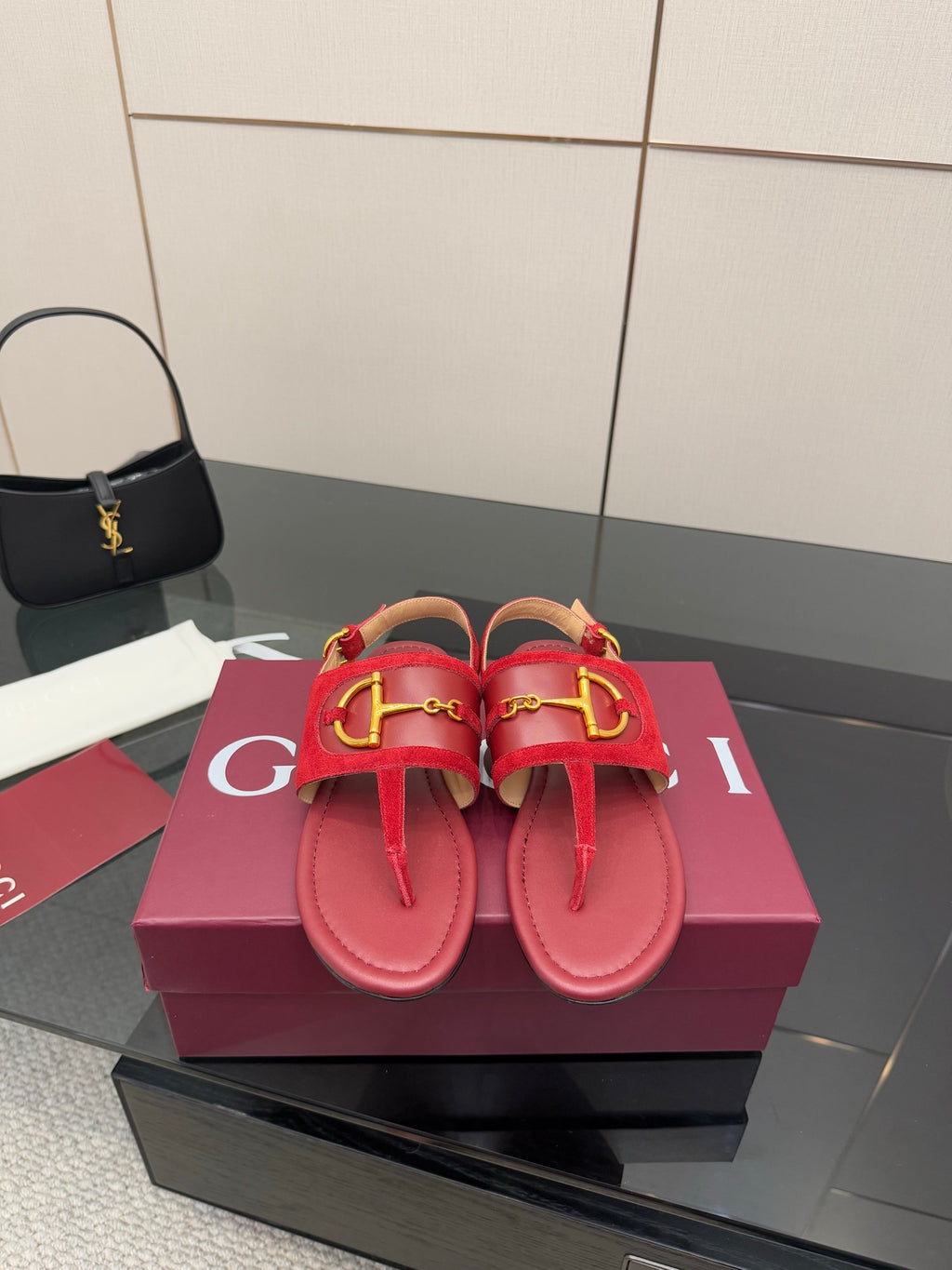 Gucci red flat sandals with gold-tone horsebit detail