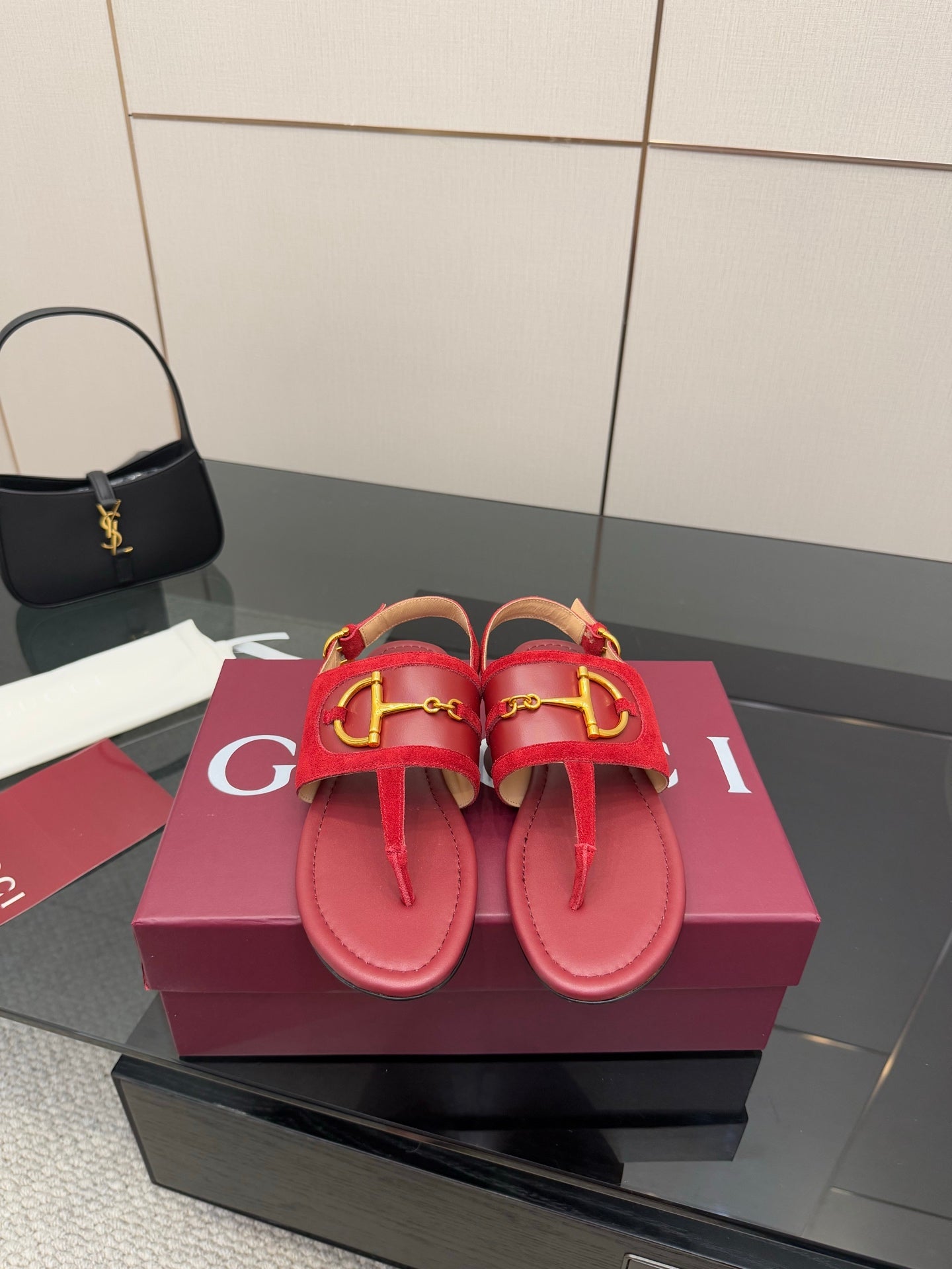 Gucci red flat sandals with gold-tone horsebit detail