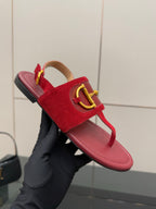 Gucci red suede slide sandals with gold-tone buckle hardware