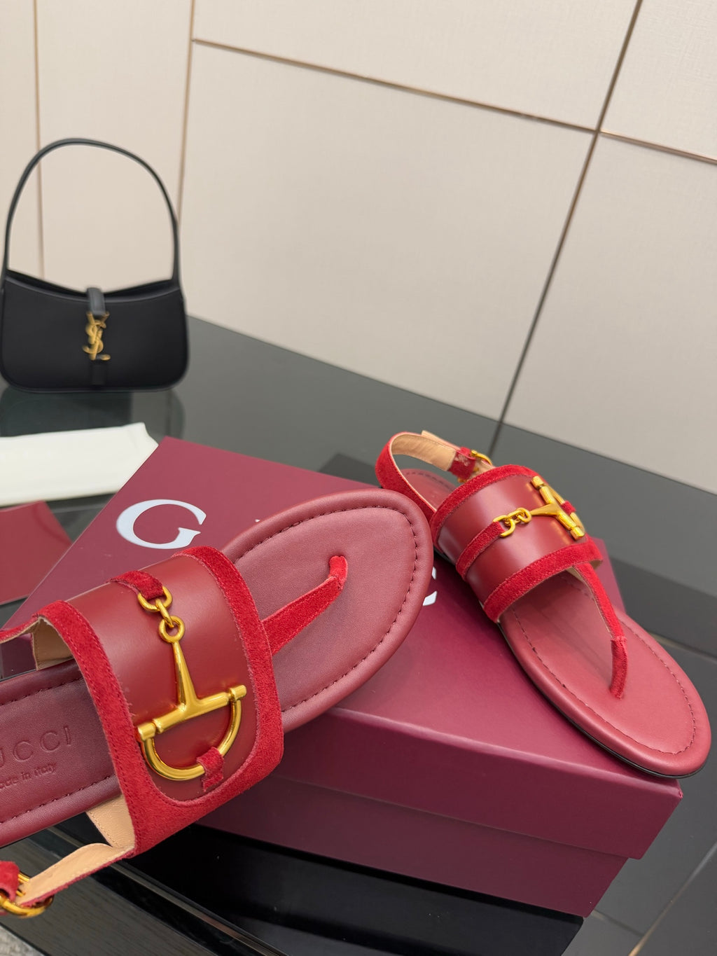 Gucci red slide sandals showing gold-tone horsebit detail on strap