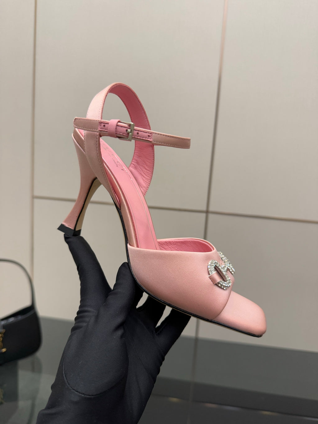 Pink pointed-toe heeled sandals with slim ankle strap and jewel buckle detail