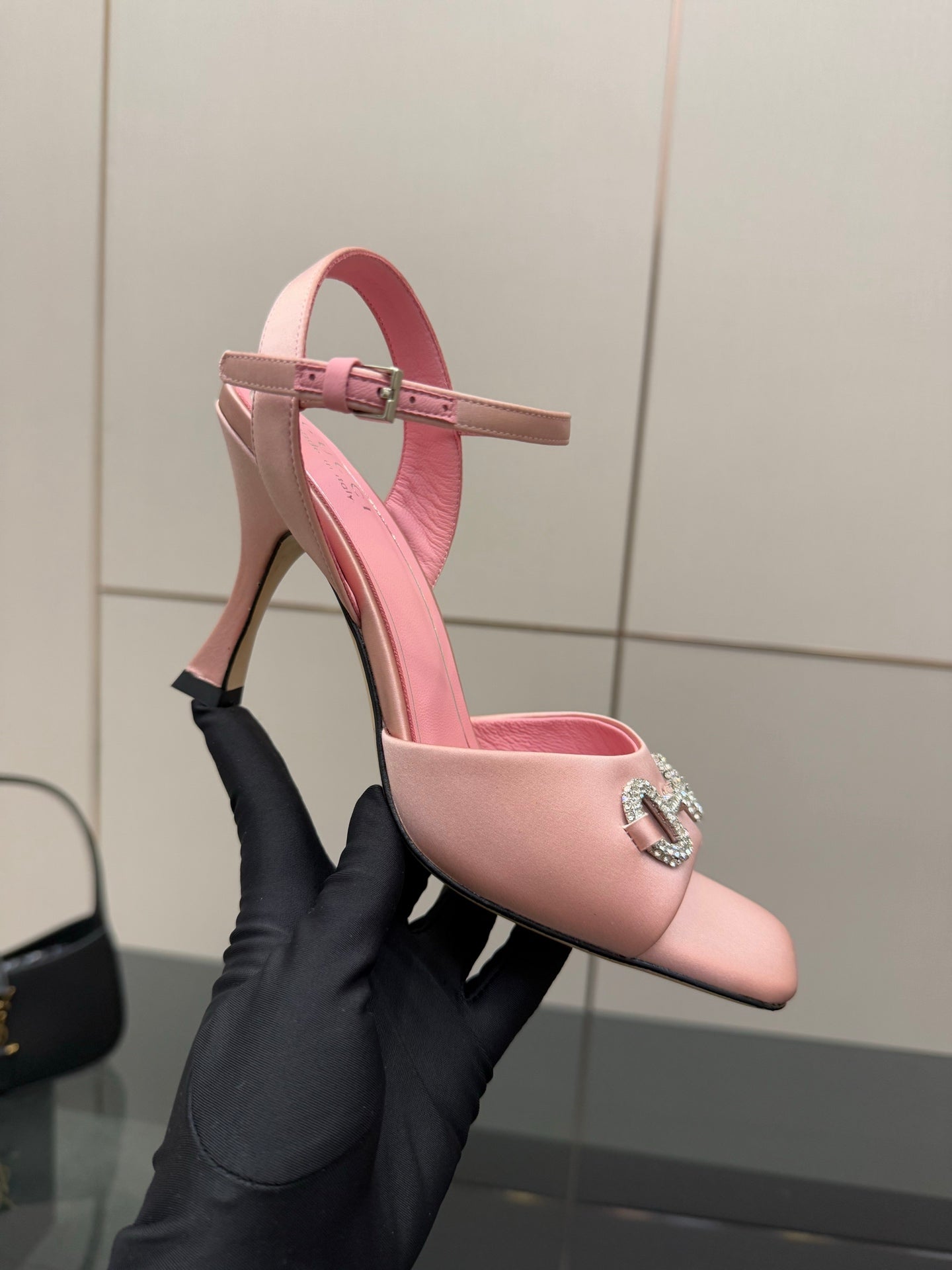 Pink pointed-toe heeled sandals with slim ankle strap and jewel buckle detail