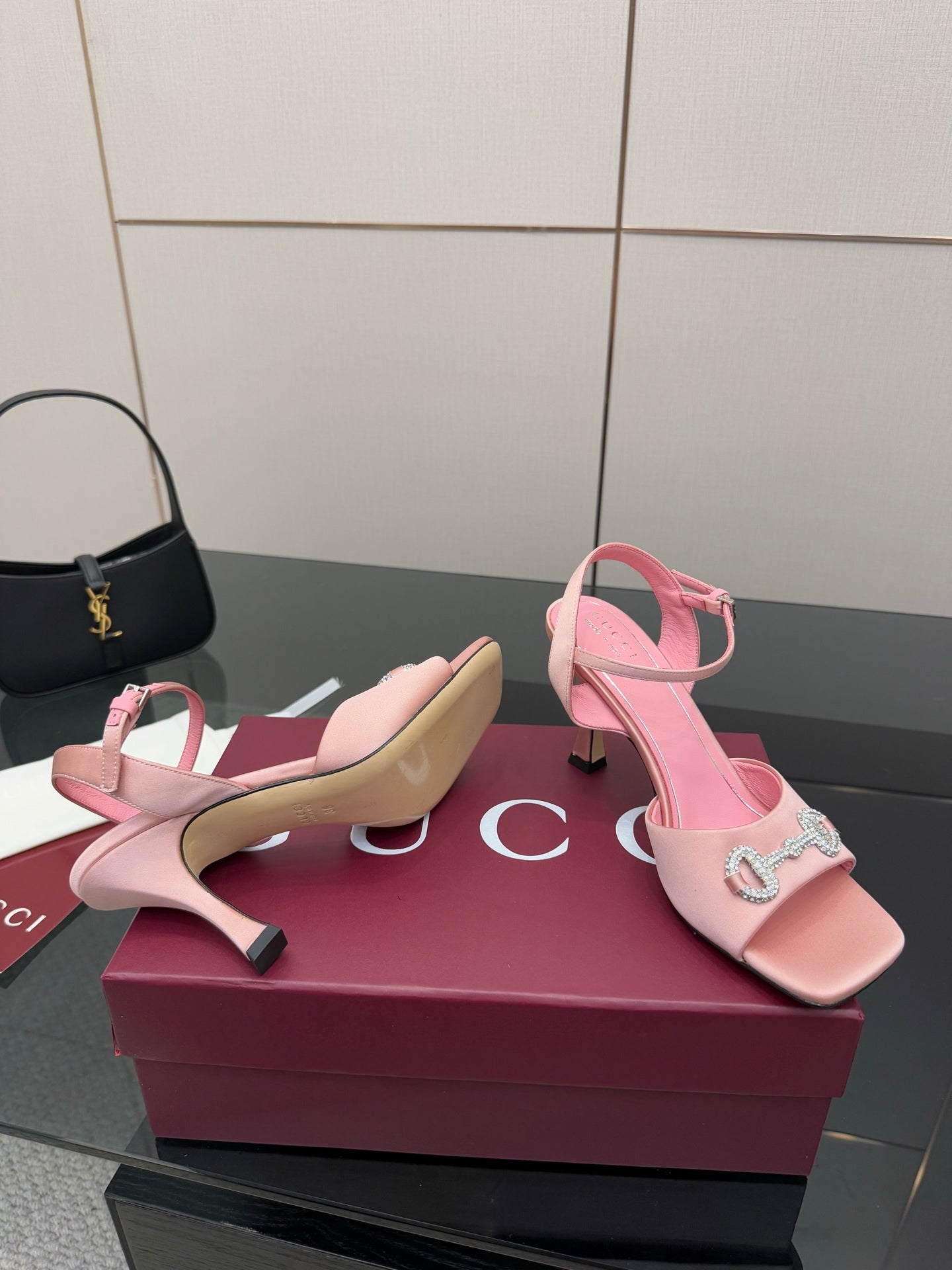 Pink slingback heeled sandals with open toe and jeweled buckle ornament