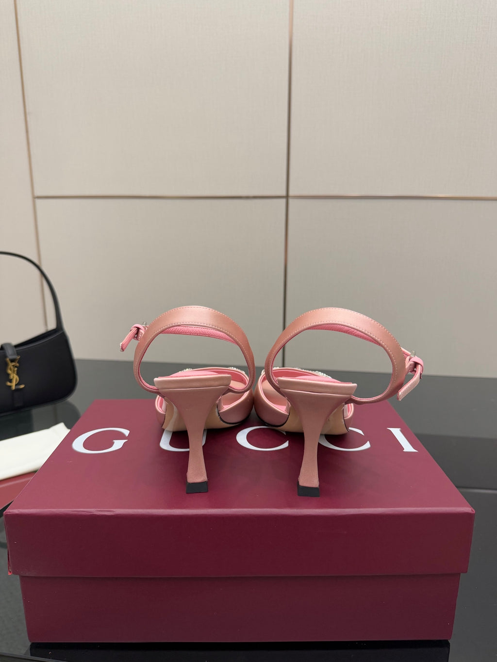 Pink heeled slingback sandals with open back strap and jeweled buckle detail
