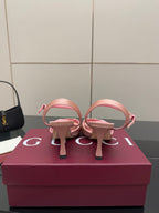 Pink heeled slingback sandals with open back strap and jeweled buckle detail