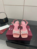 Pink women's heeled sandals with open toe and embellished buckle strap