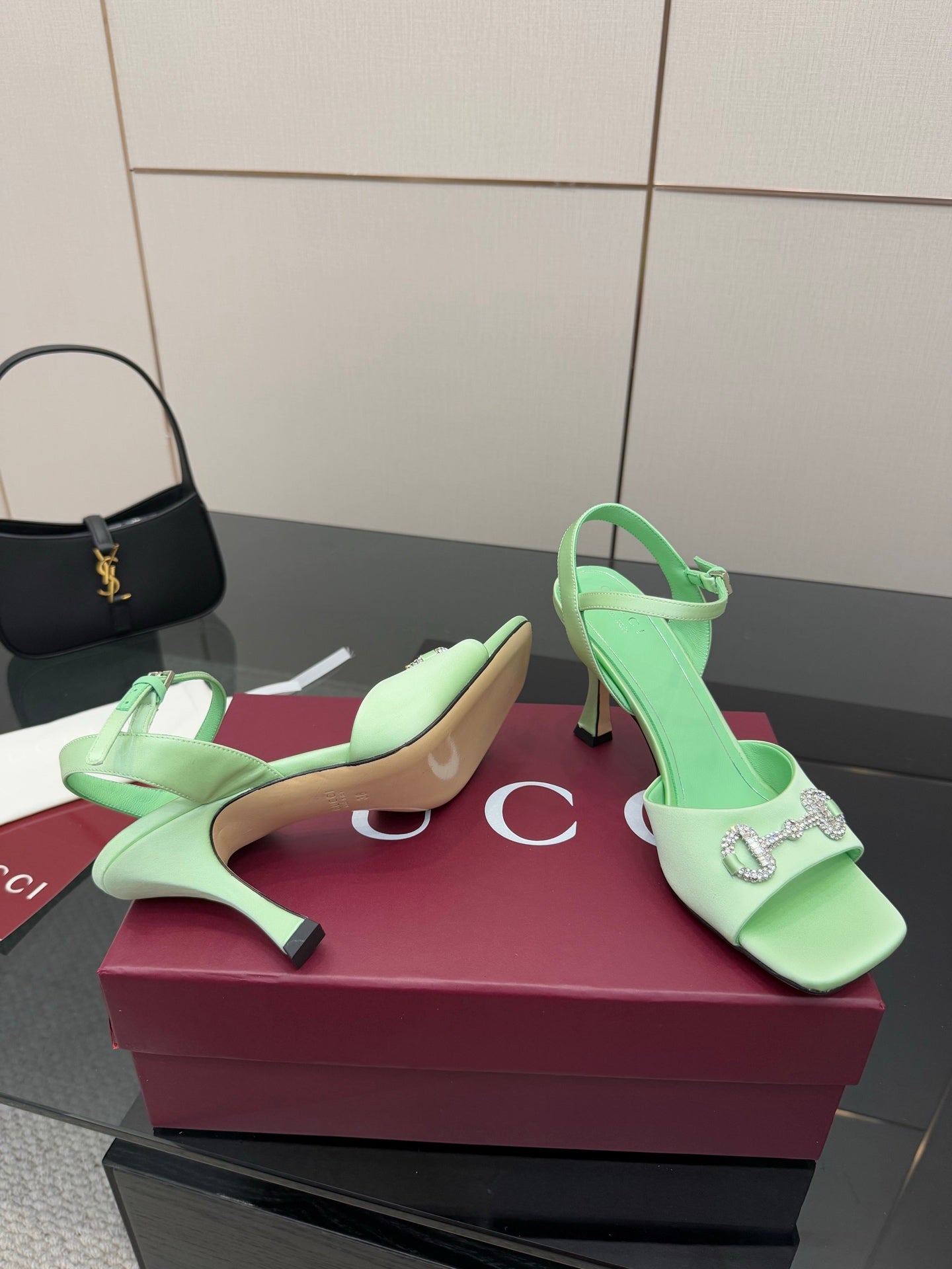 Mint green heeled sandals with rhinestone-adorned strap and pointed toe, stiletto
