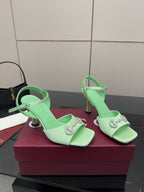 Mint green slingback heeled sandals with rhinestone buckle and slim stiletto heels
