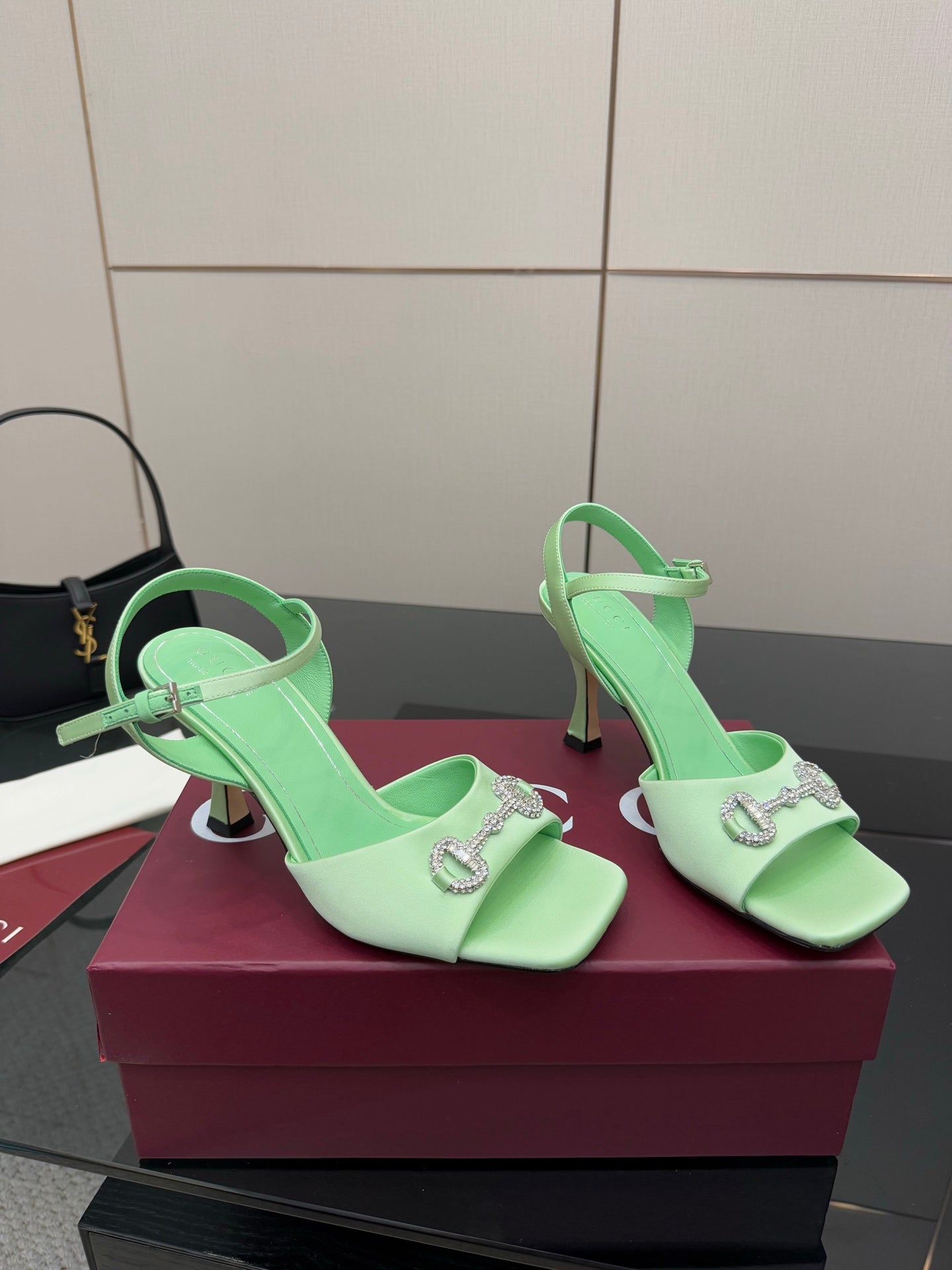 Mint green slingback heeled sandals with rhinestone buckle and slim stiletto heels