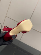Red Gucci heeled sandal sole view, showing heel and embossed brand marks