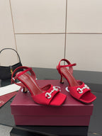 Red Gucci heeled sandals with sparkling buckle hardware and thin heel