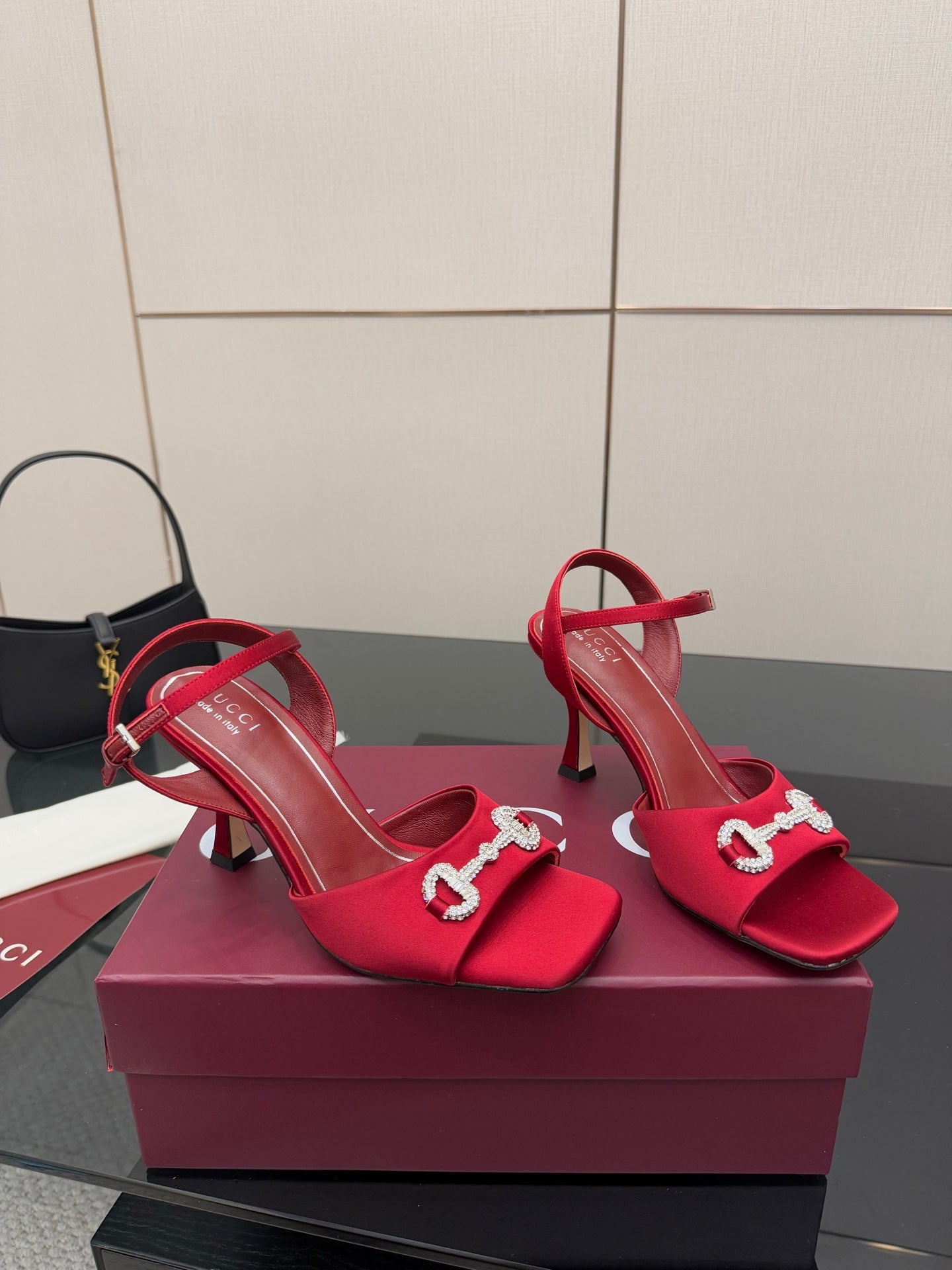 Red Gucci heeled sandals with sparkling buckle hardware and thin heel