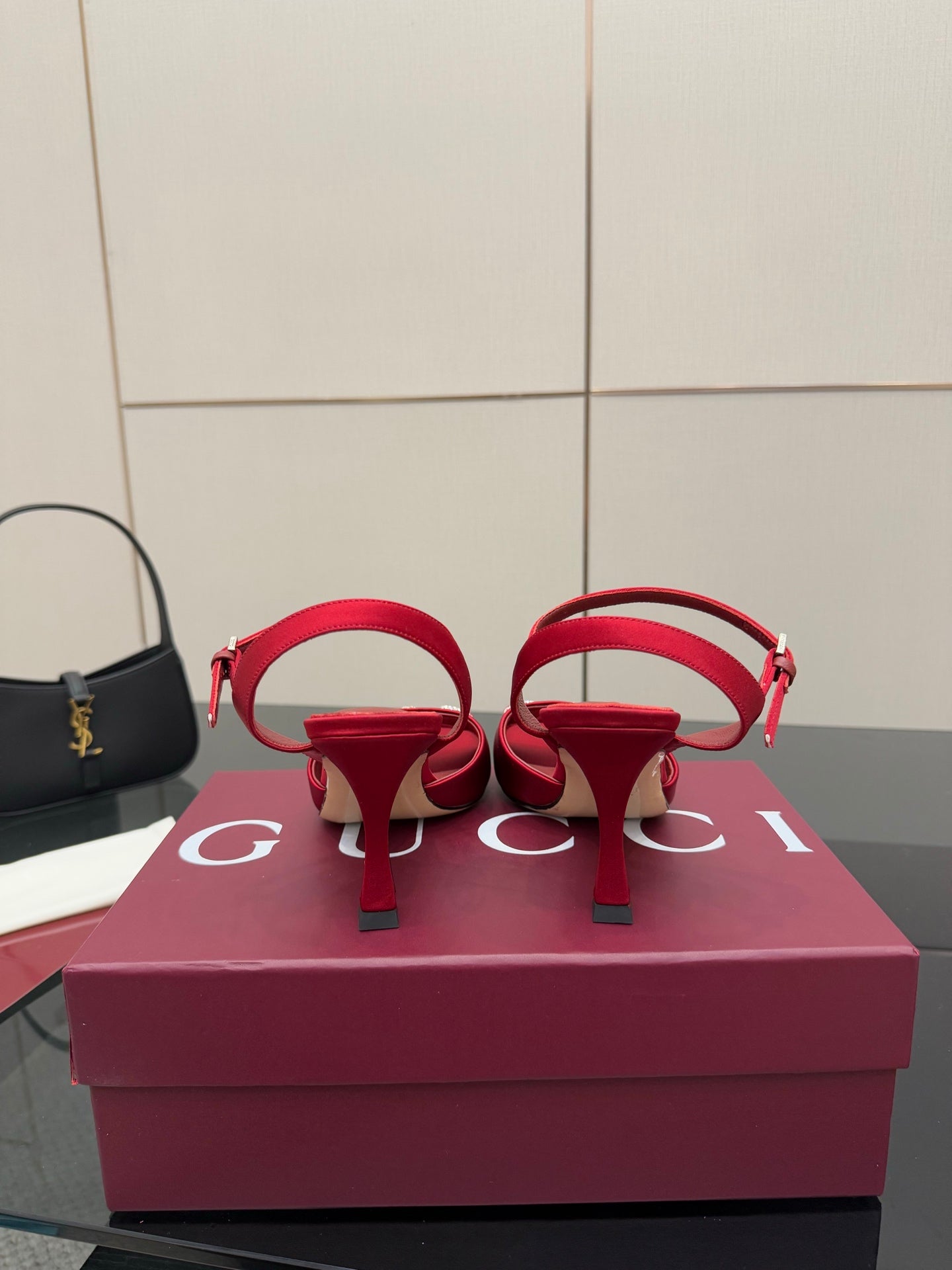 Red Gucci heeled sandals with double strap and rhinestone horsebit detail