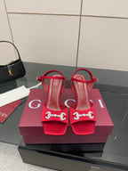 Red Gucci ladies heeled sandals with rhinestone horsebit detail and ankle strap